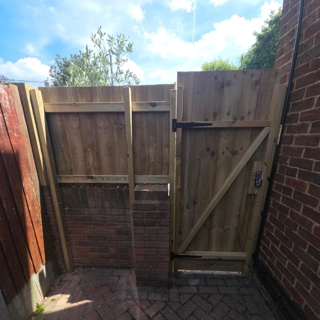 The gate from inside, with the digital lock, hinges and braced frame