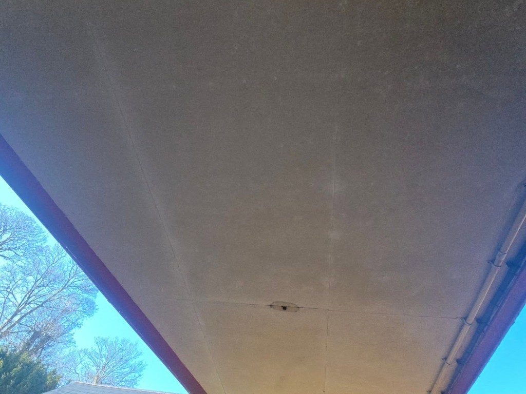 Damaged boarding on the underside of the canopy