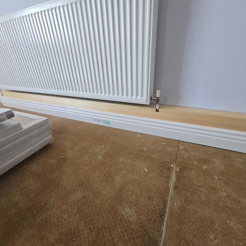 New skirting going in around the radiator pipework