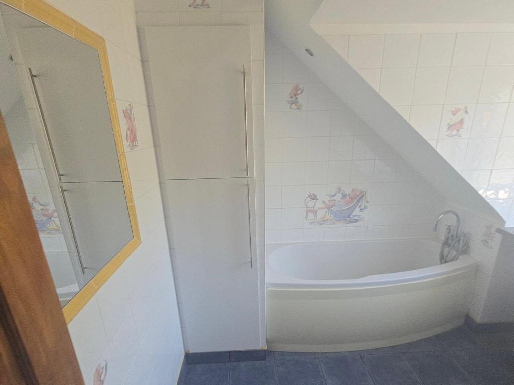 The original bath, cabinets and tiled walls before the strip-out