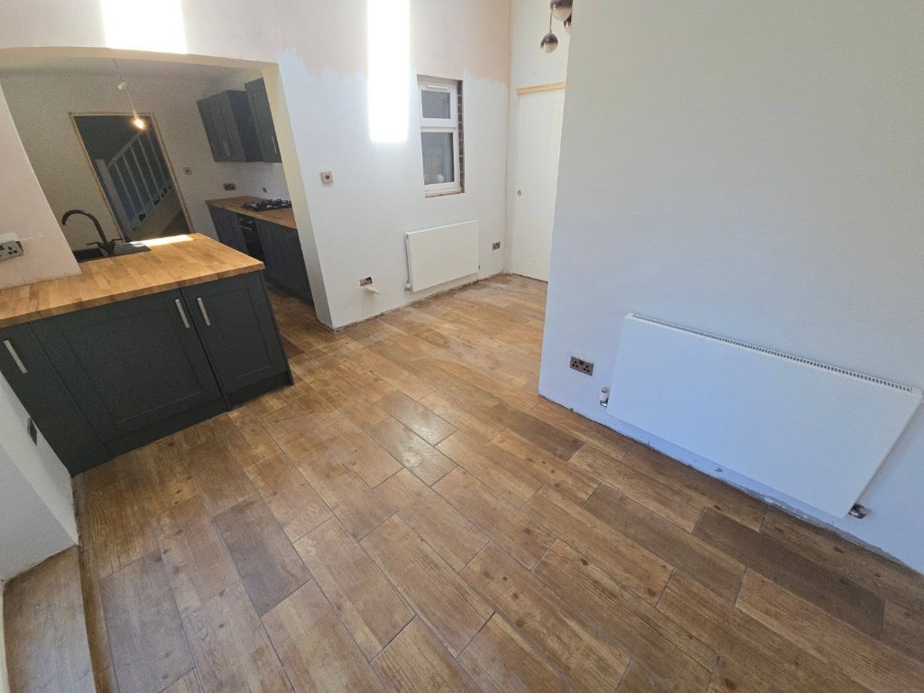 Tiled wood-effect floor and radiators in the extension