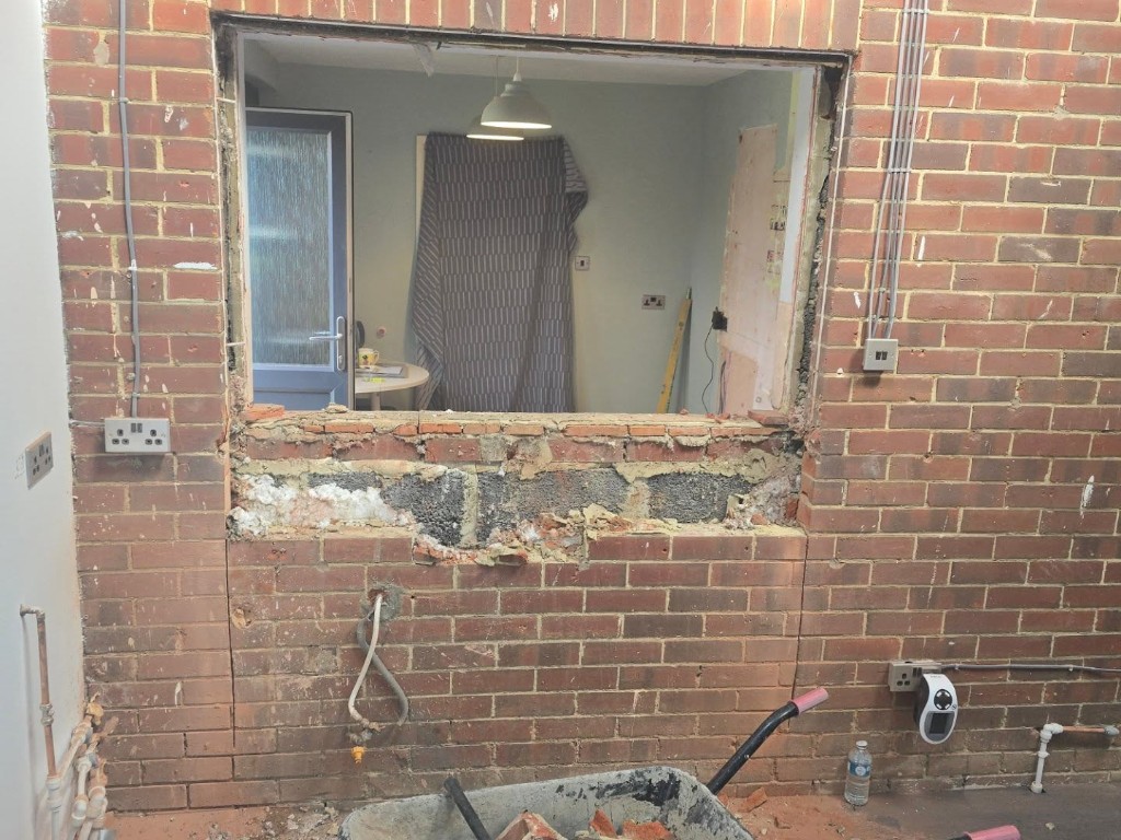 The window and lower wall opened up between the two rooms