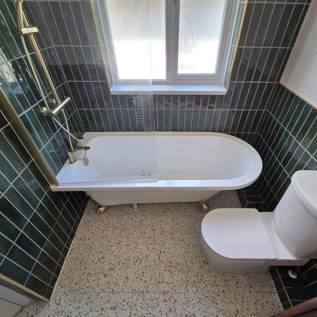 Finished bathroom with the roll top bath, terrazzo floor and toilet