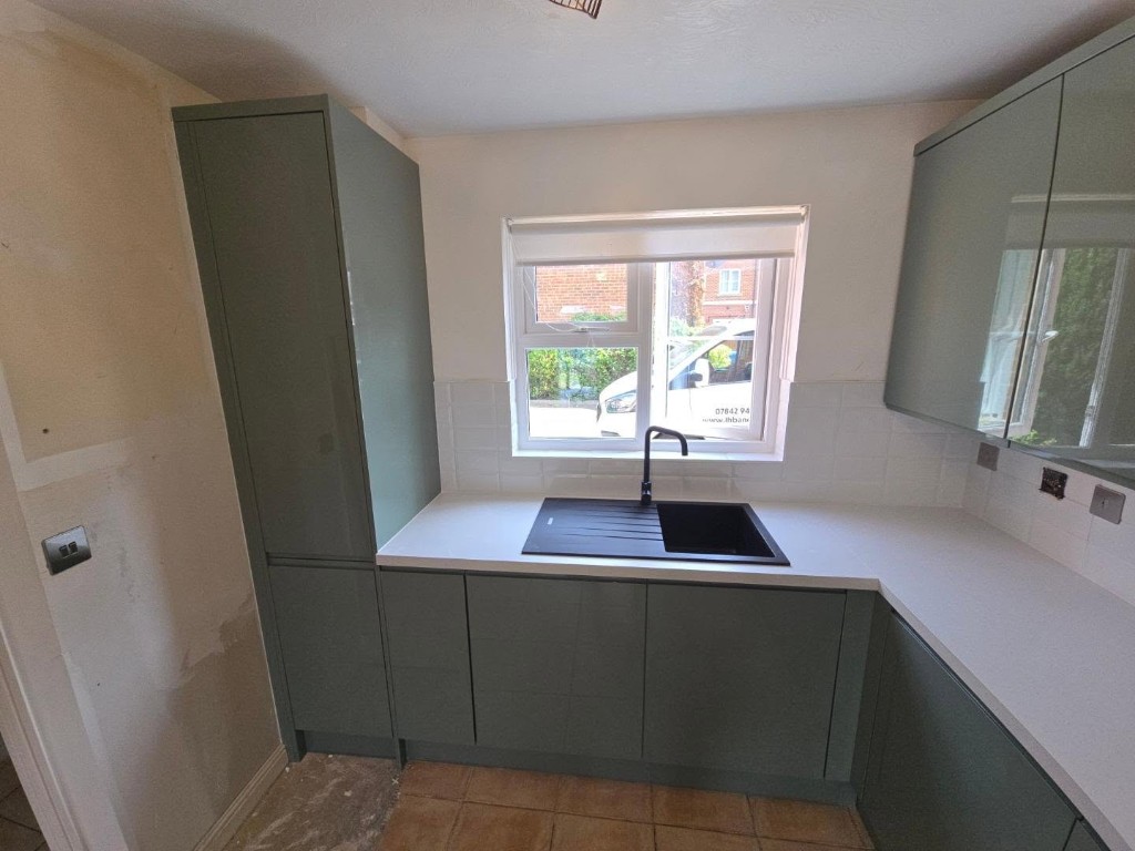 New units and sink fitted, with the wall beside the tall cabinet still to be finished