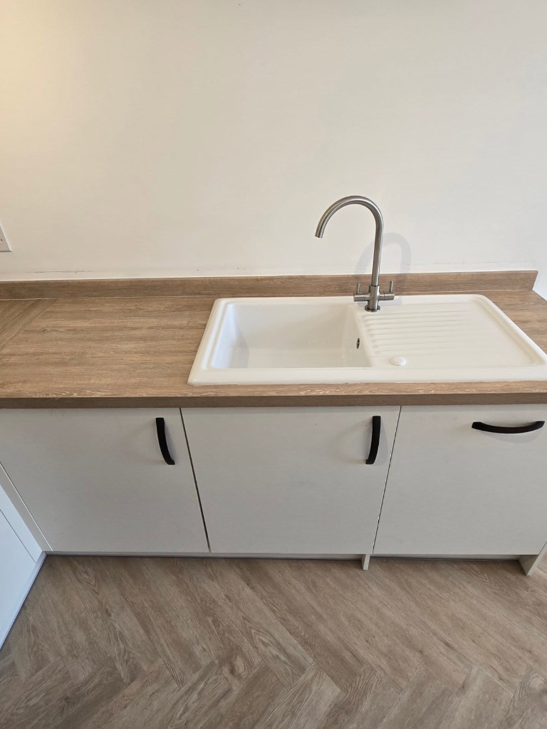 New ceramic sink and tap set into the light oak worktop