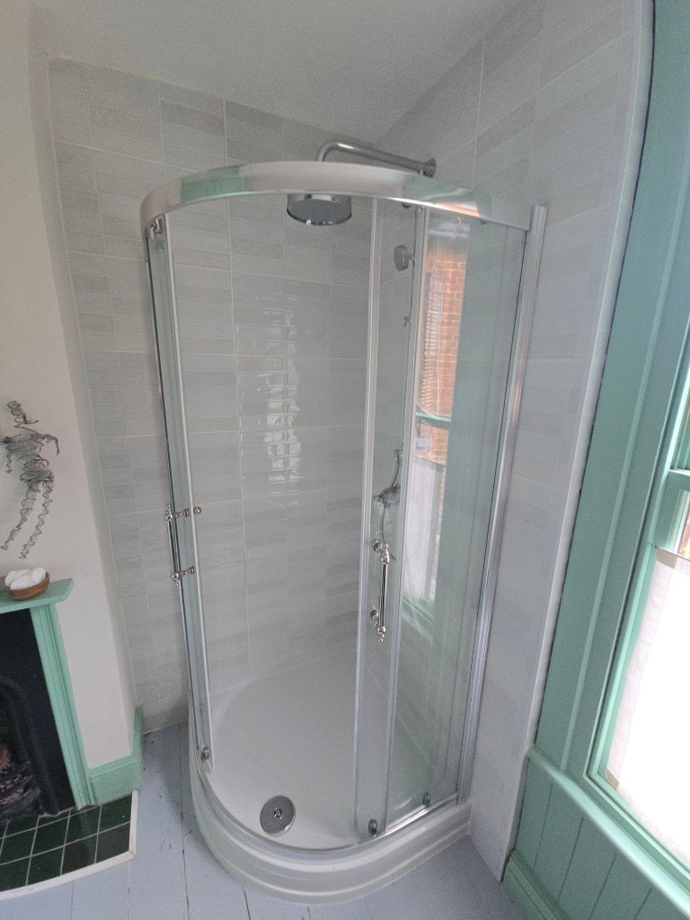 Finished quadrant shower beside the fireplace