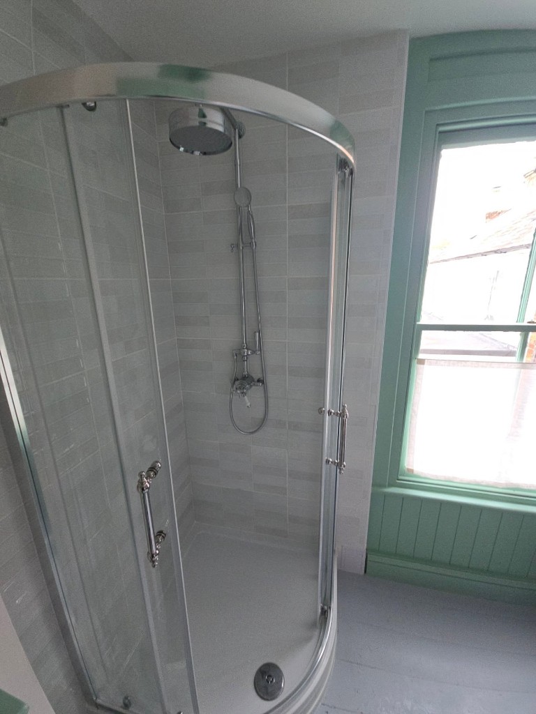 Quadrant shower enclosure beside the painted window