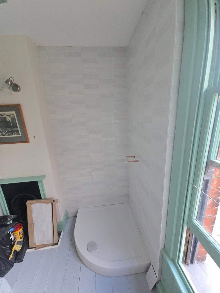 Shower walls tiled and the tray raised, ready for the new enclosure